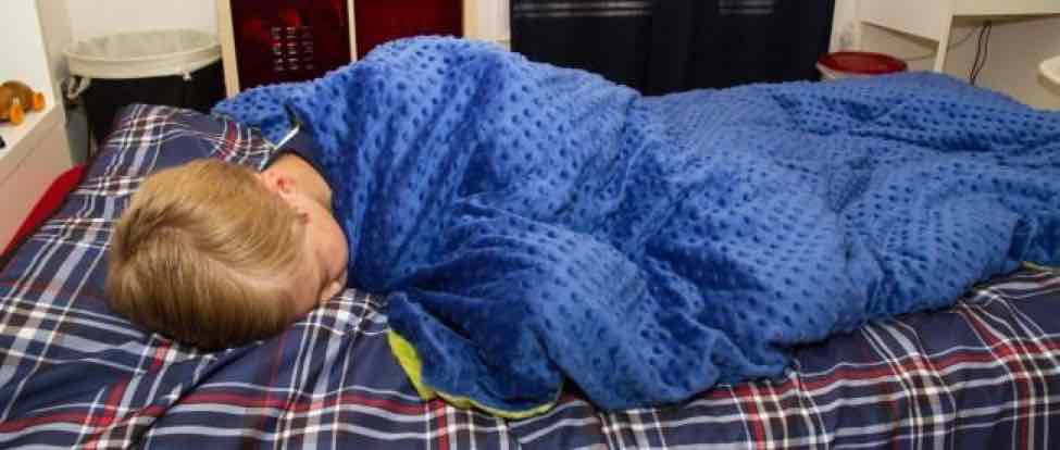 Picture of Child Wearing a Blue Weighted Blanket