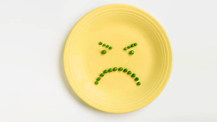 Picture of a frowny face made of peas