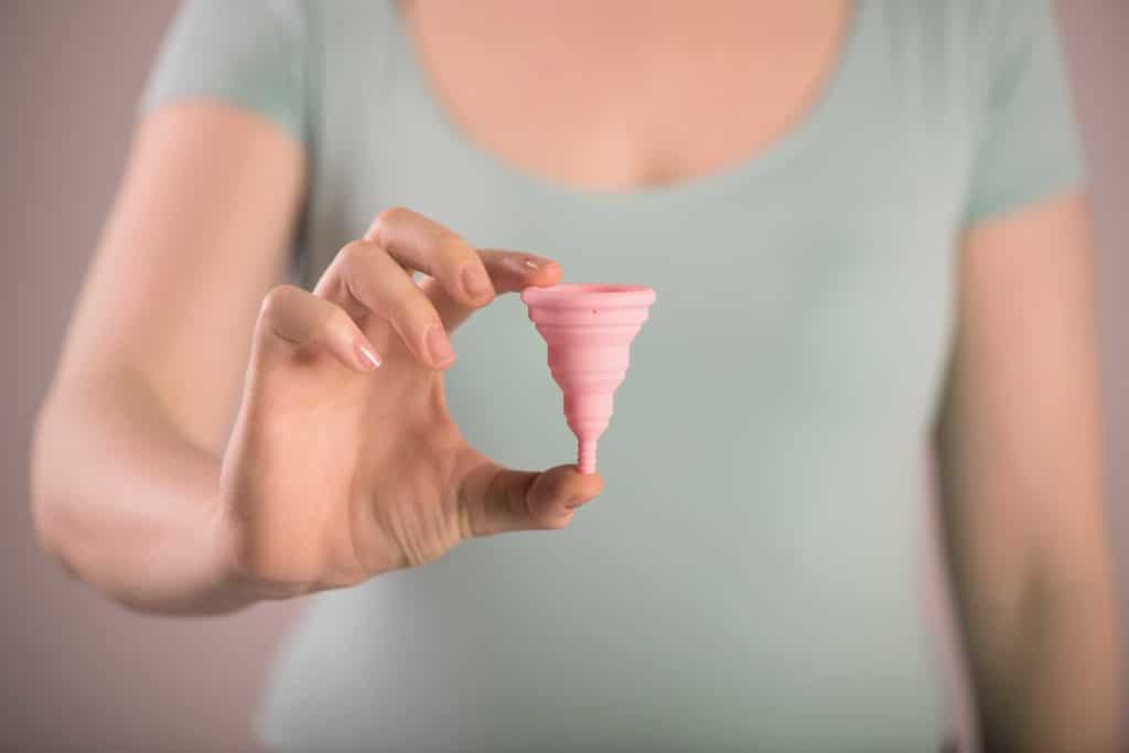 Picture of a woman holding a menstrual cup