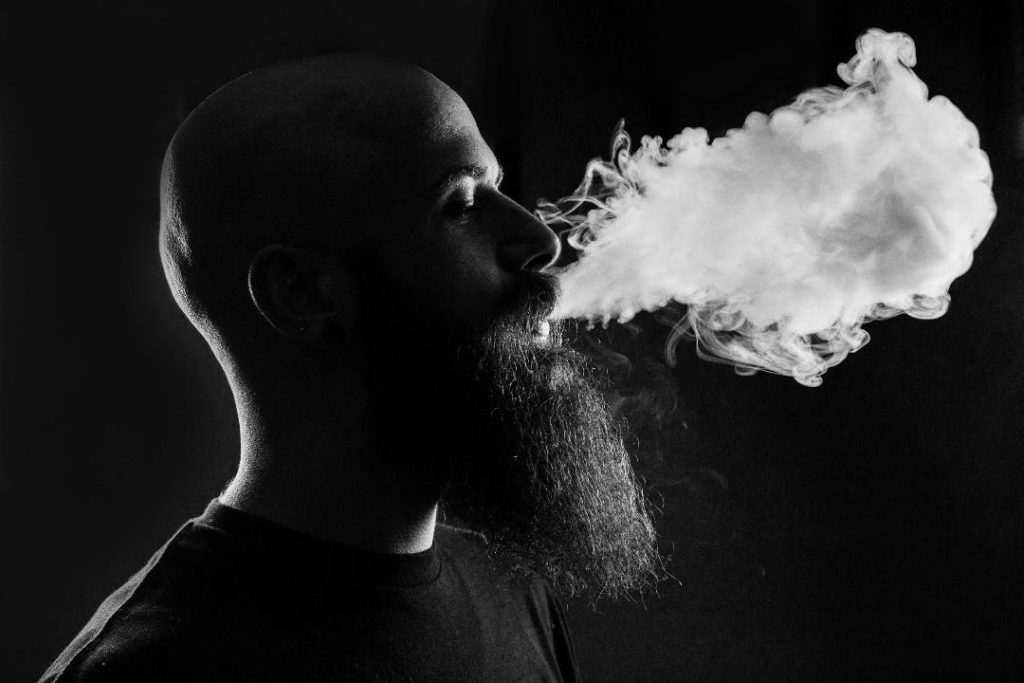 Picture of a man doing direct lung vaping