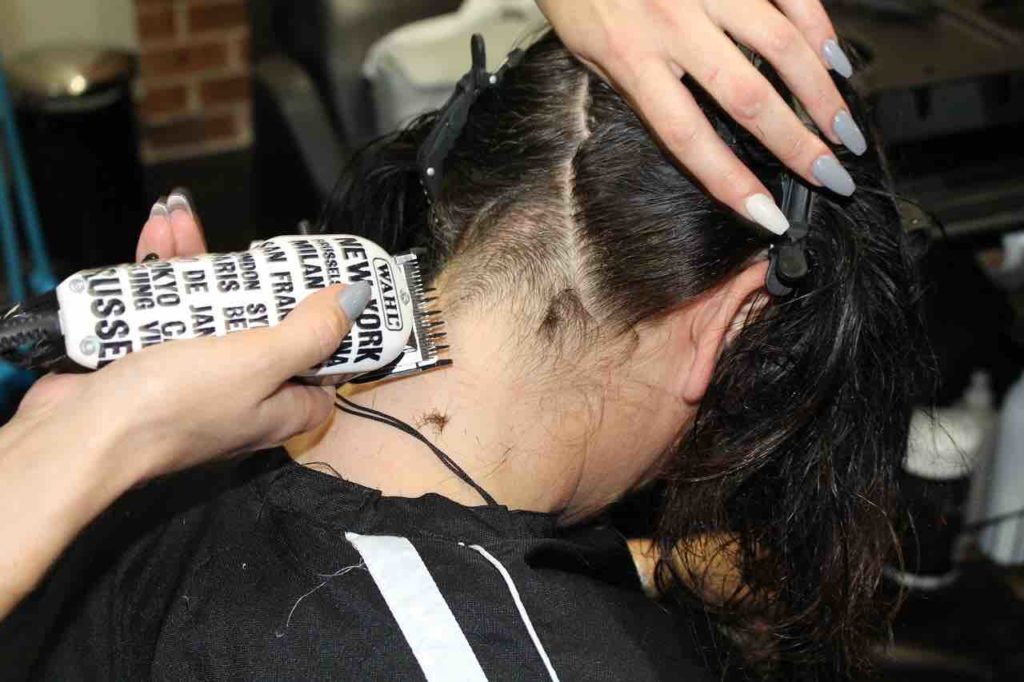 Picture of a woman getting her hair trimmed