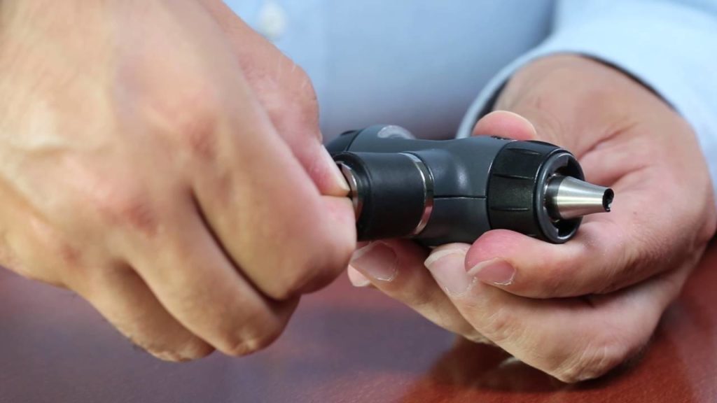 Picture of a doctor holding an ophthalmoscope