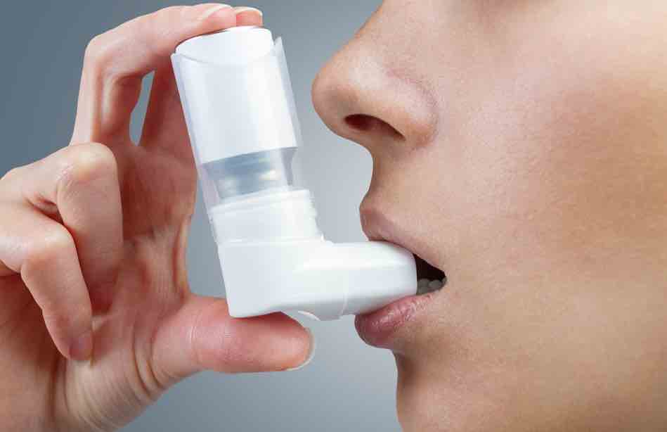 Picture of a woman using an inhaler