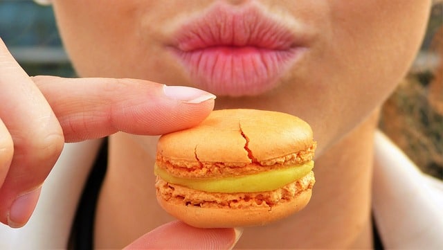 Picture of a woman holding a macaron