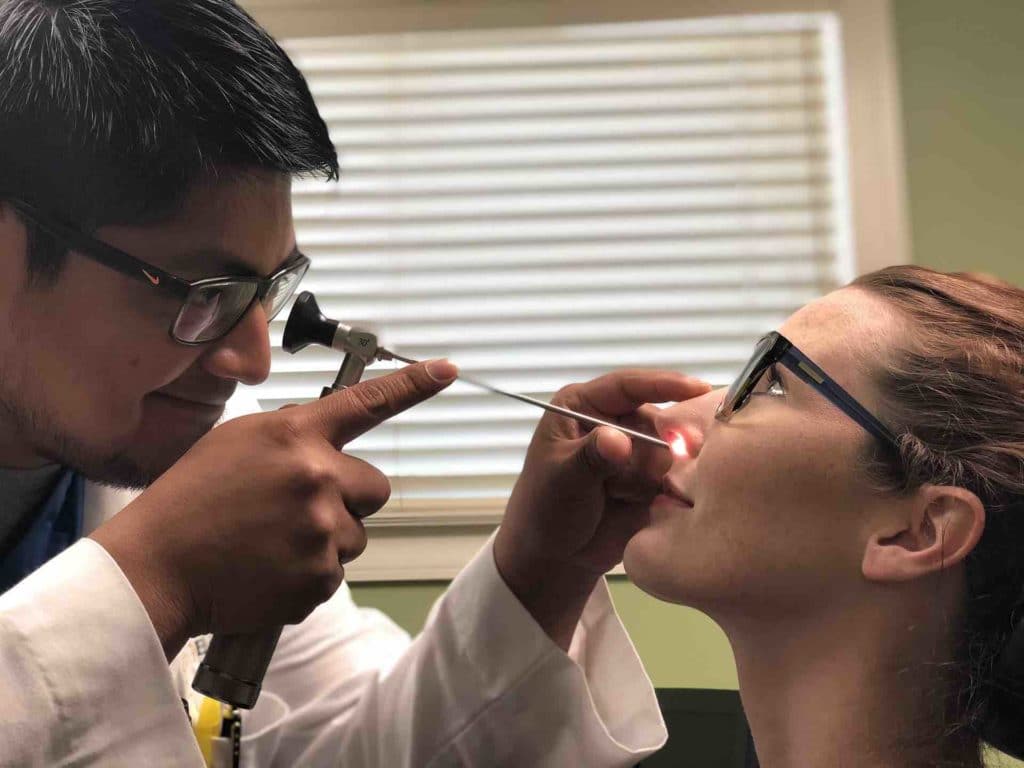 Doctor checking a patient's sinuses