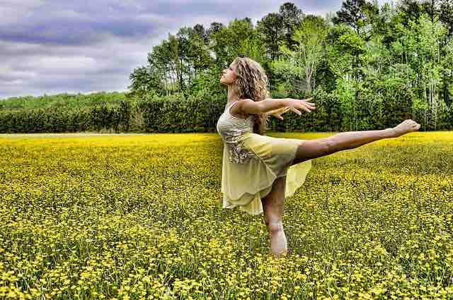 Woman dancing in a field of flowers