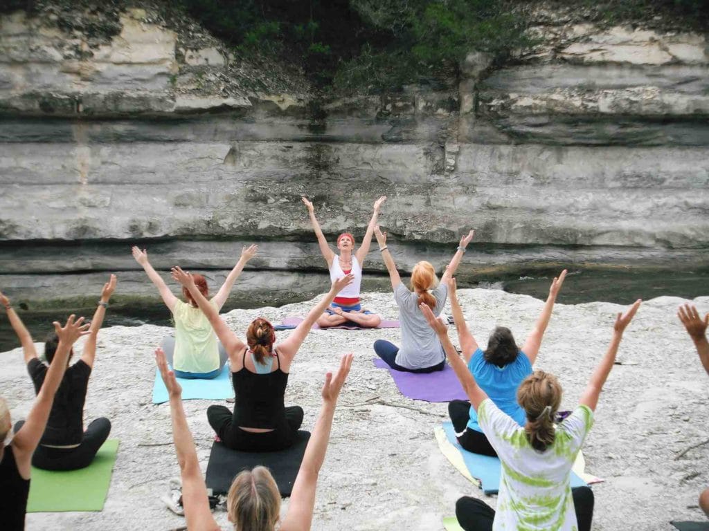 Picture of a yoga teacher and her students