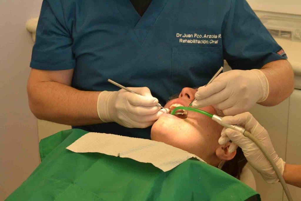 Dentist working on a teenage patient