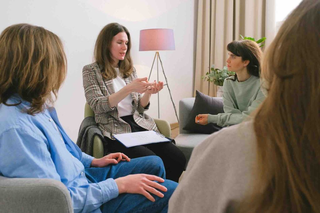 Woman leading a group therapy discussion