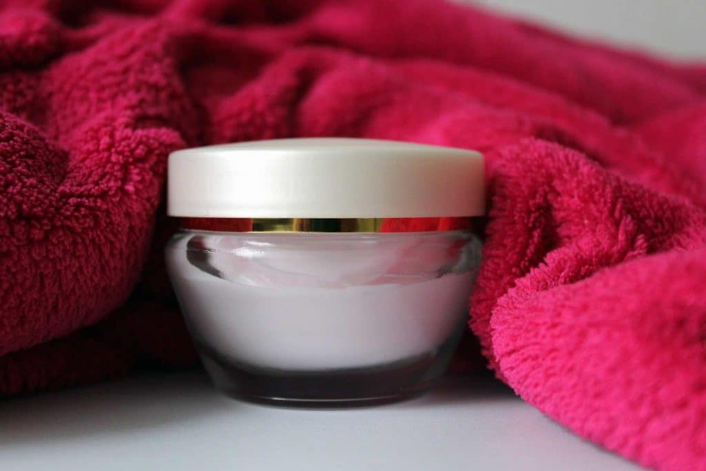 Close-up photo of generic skin cream in a glass container