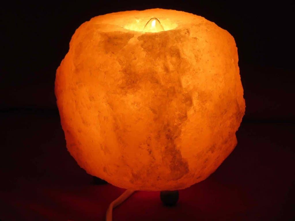Himalayan salt lamp turned on in the dark