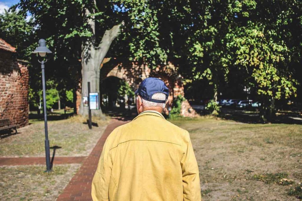 Elderly man walking outside
