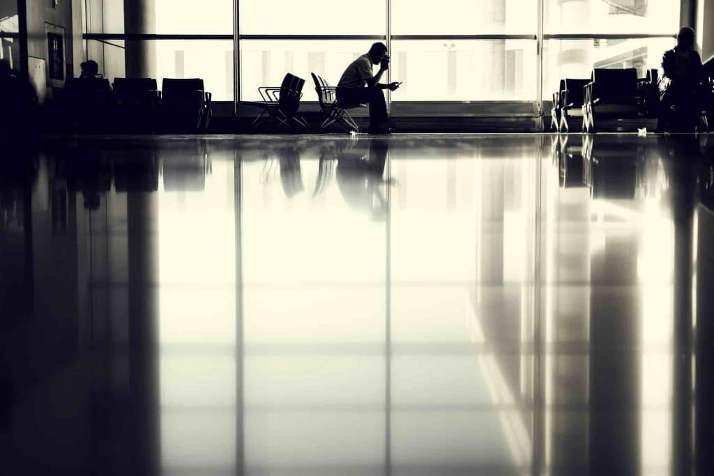 Man slouched over in an airport terminal