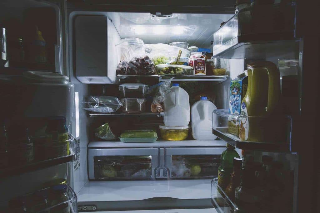 Picture of an open fridge late at night