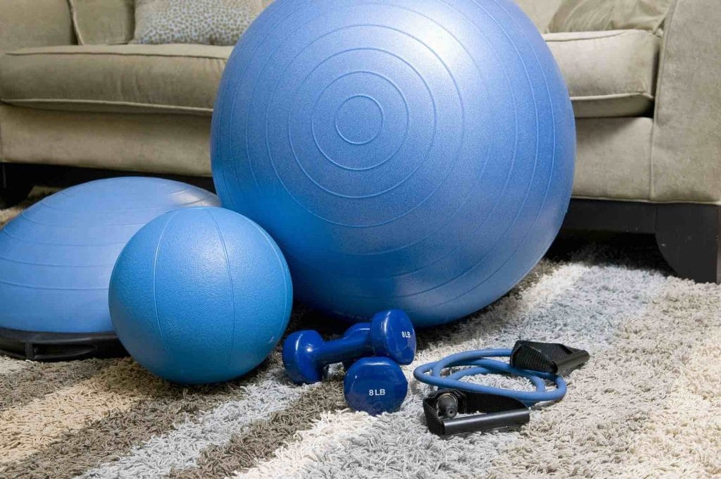 Home fitness equipment, including a balance ball, dumbbells, and jump rope