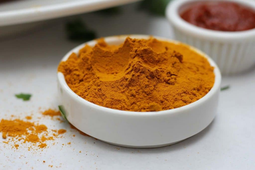 Photo of a dish filled with turmeric powder