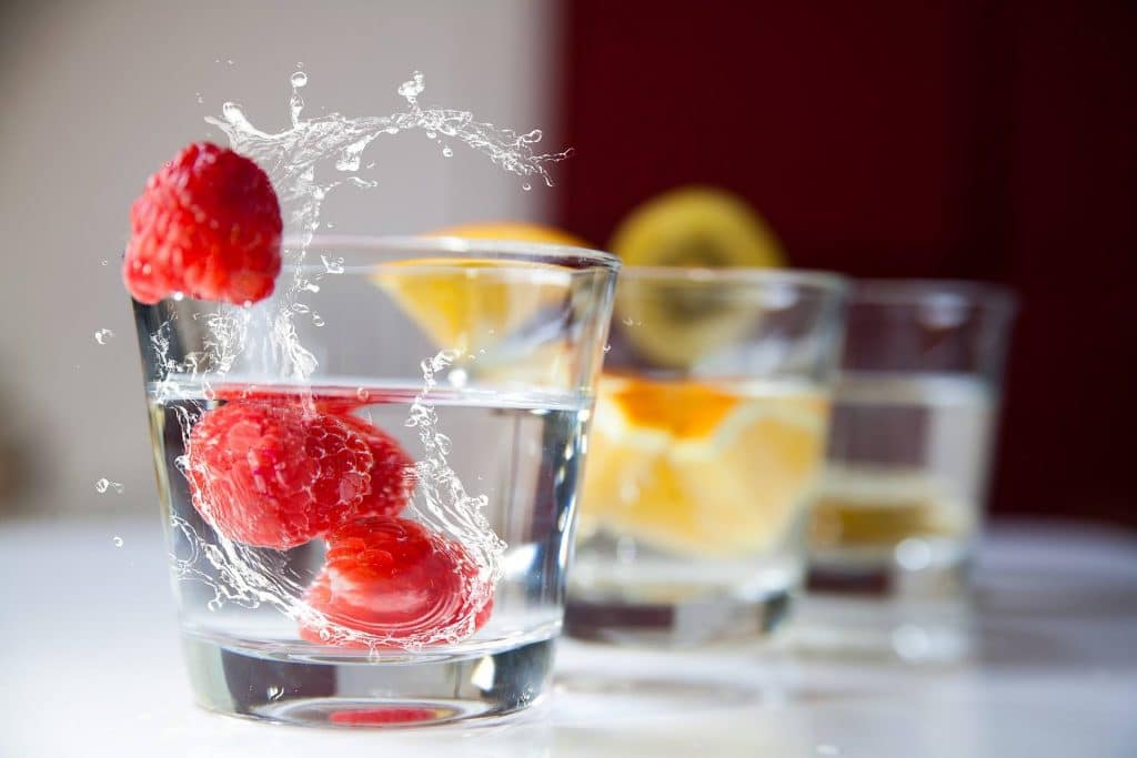 Glasses of water with fruit in it