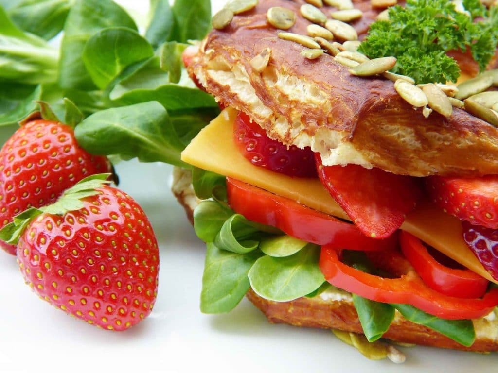 Strawberries and healthy vegetarian sandwich