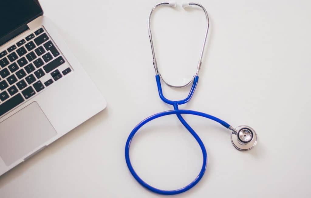 Picture of a doctor's stethoscope and laptop