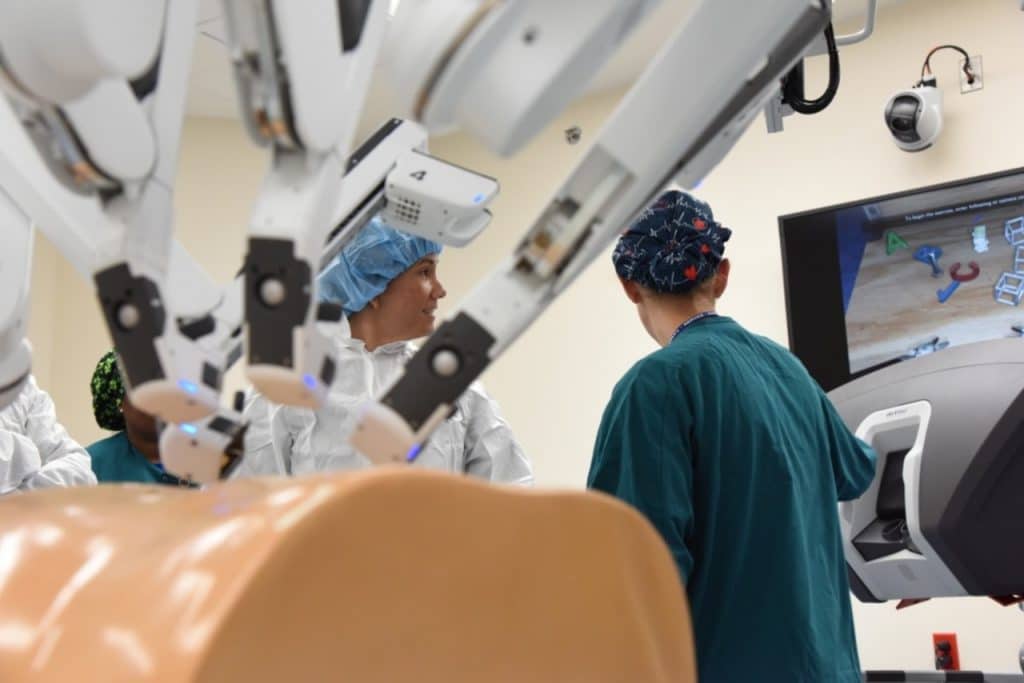 Surgeons using a telesurgery machine