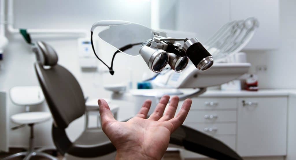 Ophthalmologist pointing to his doctor's chair