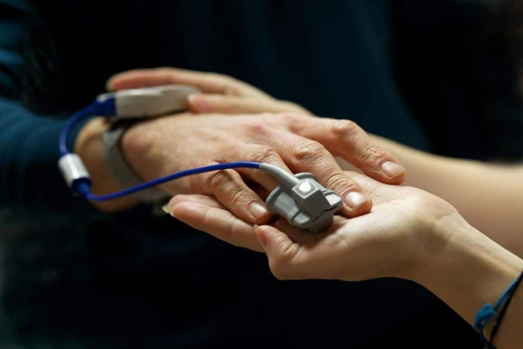 Two people testing a Personal Pulse Oximeter