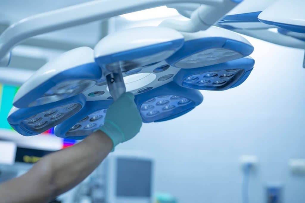 Nurse adjusting an overhead surgical light