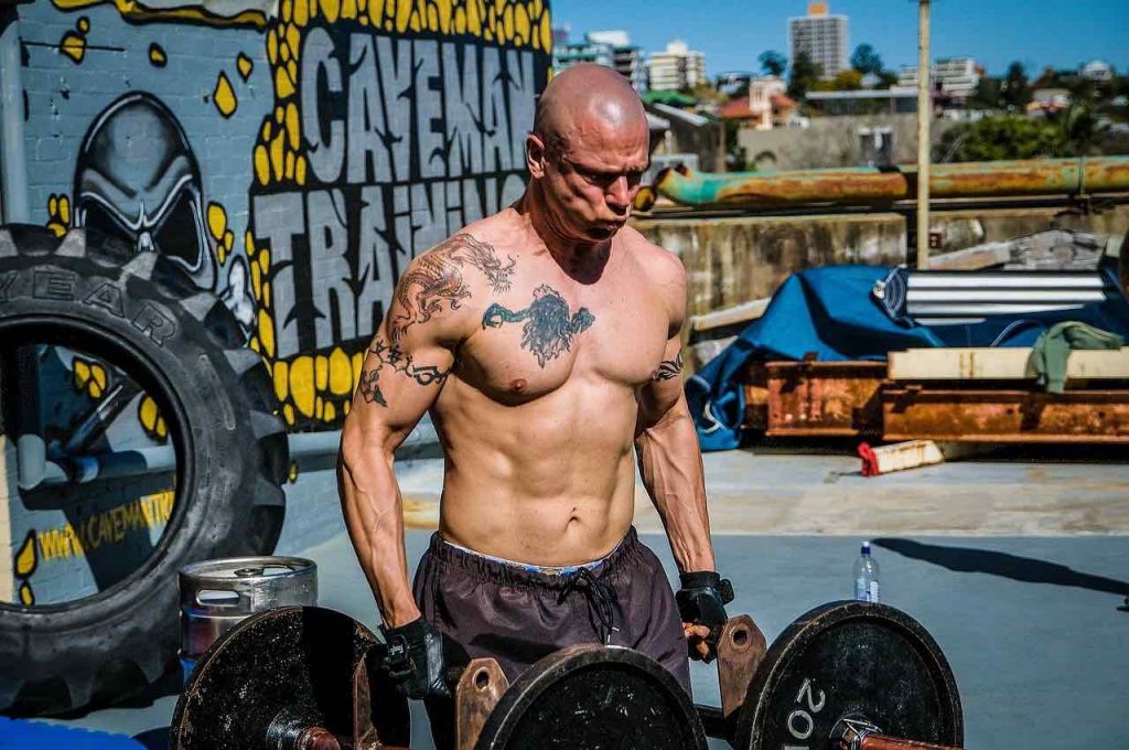 Man lifting weights outdoors
