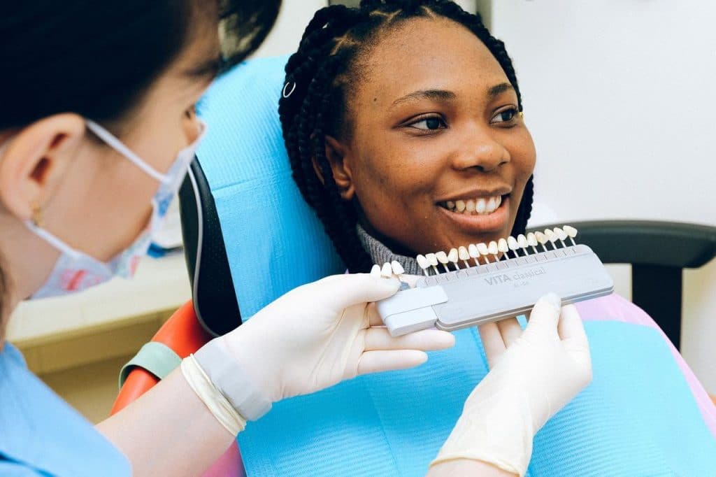 Woman looking at her new dental implant at the dentist's office