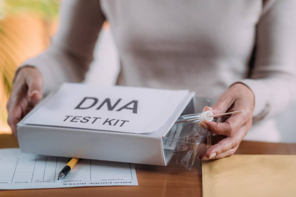 Woman opening a mail-in dna test kit