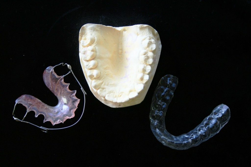 Various orthodontic treatment options against a black background