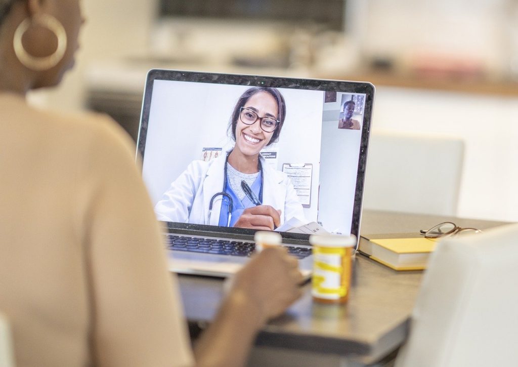 Woman receiving a consultation from a doctor in a telemedicine appointment