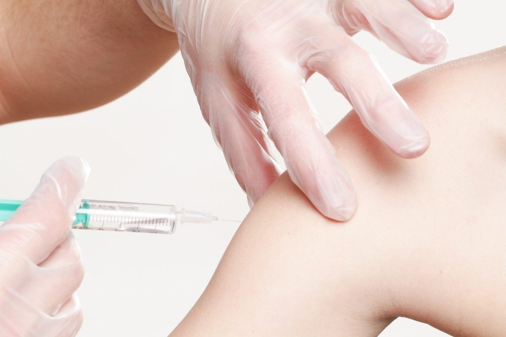 Nurse giving a child a vaccine shot