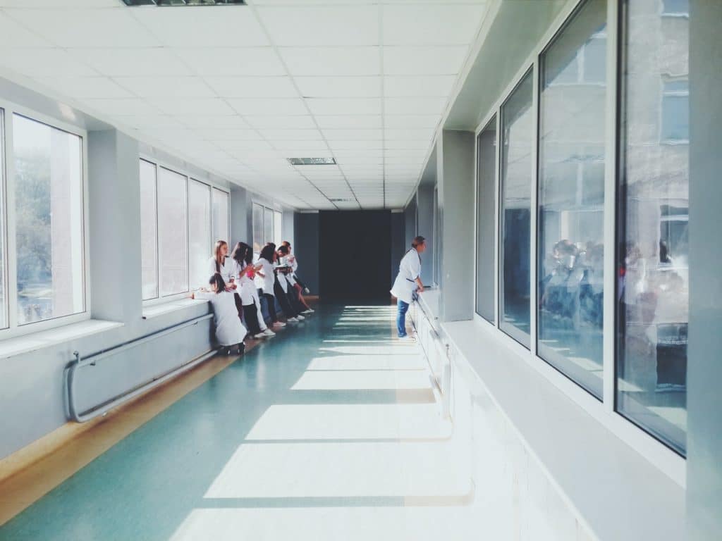 Hallway in a hospital with nurses and doctors