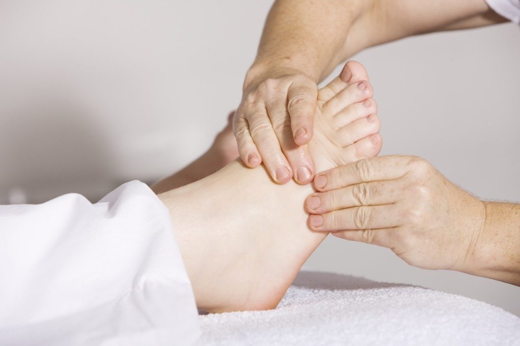 Massage therapist massaging a foot