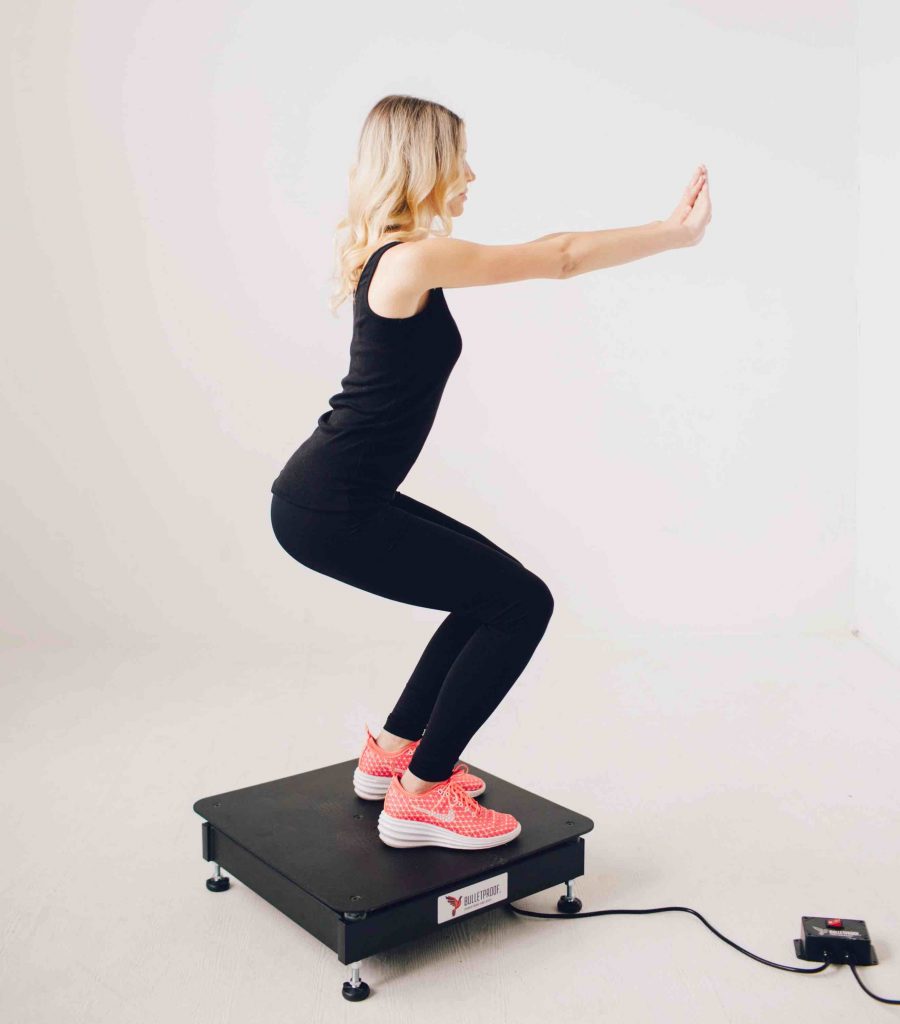 Woman standing on a vibration machine