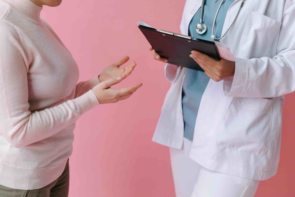 Medical professional standing with another professional